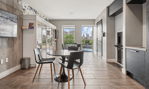 Lounge area with dining tables, chairs, and a TULU rental vending machine
